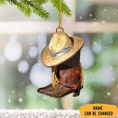 a cowboy hat ornament hanging from a tree