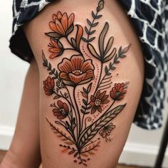 a woman's thigh with flowers and leaves on it