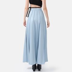 Step into effortless elegance with the Solace Vegan Leather Pleated Maxi Skirt in powder blue. With a hidden zip closure and stylish golden embellishments, this skirt combines sophistication with a touch of luxury. The lightweight fabric drapes beautifully, offering a relaxed yet structured fit with just the right amount of stretch for comfort and durability. The vertical hand-pleating creates a flattering silhouette by elongating the lower body. Perfect for stylish occasions where comfort is ke Hand Pleating, Maxi Skirt Blue, Pleated Maxi Skirt, Pleated Maxi, Effortless Elegance, Draped Fabric, Pleated Midi Skirt, Lower Body, Independent Designers Fashion