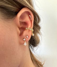 a woman wearing three different types of ear piercings on her left ear and right ear