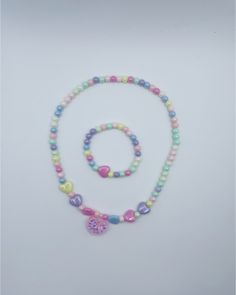 Gender: Girls Type: Necklace/Bracelet Material: plastic jewelry set Product Description: 1 necklace + 1 bracelet. *Jewelry set, colorful plastic material bead necklace, center of necklace has pink heart in delicate glitter, girls bracelets, girls birthday party jewelry gift. pattern/shape: love heart Occasion: party, birthday, gifts or any special occasion or as you like. Pink Plastic Necklaces As Gifts, Pink Plastic Necklace For Gift, Pink Plastic Necklace Gift, Cute Multicolor Plastic Necklaces, Handmade Pink Plastic Necklace, Playful Colorful Jewelry With Heart Beads, Sweet Pink Plastic Jewelry, Pink Beaded Plastic Jewelry, Trendy Pink Plastic Necklaces