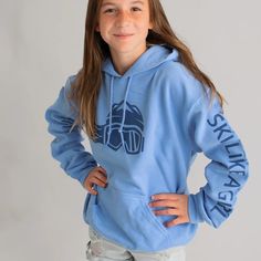 Ski Like A Girl Womens Hoodie Carolina Blue Navy | Ski Like A Girl Blue Adjustable Hood Sweatshirt For Outdoor, Blue Sweatshirt With Adjustable Hood For Outdoor, Blue Cotton Hoodie For Outdoor Activities, Long Sleeve Hoodie With Adjustable Hood For Winter Sports, Casual Hoodie For Winter Sports, Sporty Cotton Hoodie For Winter Sports, Sporty Light Blue Sweatshirt For Winter, Ski Girls, Navy Logo