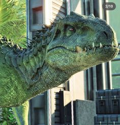 a close up of a dinosaur in front of a building