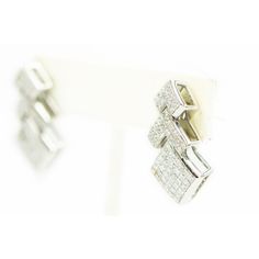 Impressive 1.10" long geometric 18k white gold earrings featuring three sections of invisible set princess cut diamonds. They have post and omega backs. Silver Platinum Earrings With Baguette Diamonds, Formal Baguette Diamond Rectangular Earrings, Formal Rectangular Baguette Diamond Earrings, Luxury Rectangular Diamond Earrings With Accents, Luxury White Gold Diamond Earrings In Rectangular Shape, Luxury White Gold Diamond Earrings Rectangular, Modern Silver Jewelry With Baguette Diamonds, Luxury White Gold Rectangular Diamond Earrings, Luxury Rectangular Diamond Cut Earrings