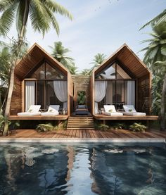 two wooden houses sitting next to each other on top of a pool surrounded by palm trees