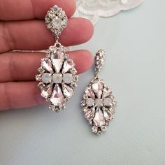 Hollywood Glam crystal earrings, made with top Swarovski rhinestones hand sett on silver filigree drop . finished with hypo allergenic surgical steal ear wire. Original design , hand crafted by me in my studio. Light weigh and very comfortable to wear . Other related accessories are coming soon ( necklace) Suggested Bracelet: https://www.etsy.com/listing/721178495/white-opal-wedding-cuff-bracelet-crystal?ref=shop_home_active_7 Please contact me if you have any questions. Dazzling White Teardrop Crystal Earrings, Crystal Chandelier Earrings With Sparkling Stones As Gift, White Crystal Chandelier Earrings With Rhinestones, White Crystal Chandelier Earrings For Formal Occasions, Crystal Embellished Dangle Earrings, Formal White Crystal Chandelier Earrings, Sparkling Silver Crystal Bridal Earrings, Dazzling White Crystal Dangle Earrings, Diamond White Crystal Chandelier Dangle Earrings