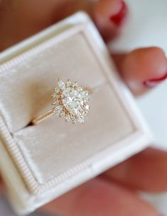 a woman's hand holding an engagement ring in a box with the words sunday, island on it