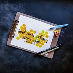 a piece of paper with writing on it next to a pen and marker, which is laying on a table