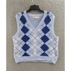 Crave Fame Argyle Sweater Vest Juniors' Xl Blue Combo V- Neck Sleeveless~ Crave Fame Argyle Sweater Vest Juniors' Xl Blue Combo V- Neck Sleeveless Retail: $34.00 This Crave Fame Sweater Vest In A Beautiful Blue Combo Color Is Perfect For A Casual Or Travel Occasion. The V-Neckline And Sleeveless Design Make It Breathable And Comfortable To Wear. The Vest Features A Collarless, Classic, And Preppy Style With An Argyle/Diamond Pattern. The Tight-Knit Fabric Type Of 100% Polyester Is Machine W Blue Sleeveless Sweater Vest For Winter, Blue Casual Sleeveless Sweater Vest, Trendy Blue Vest Top, Trendy Sleeveless Blue Vest, Trendy Blue Sleeveless Vest, Trendy Blue Sleeveless Sweater Vest, Blue V-neck Tank Top For Fall, Blue V-neck Sweater Vest For Winter, Blue Sleeveless Winter Top