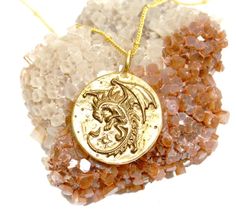 This pendant depicts a flying dragon on one side, and a baby dragon on the reverse. The dragon, a legendary creature symbolizes protection, success, wisdom, loyalty, fearlessness, strength, balance, and immense possibility. Being the master of all four elements of Fire, Water, Earth, and Wind, it also embodies primordial power.This is a large medallion which measures:1 1/8 inch in diameter, made in white bronze, and oxidized for contrast.This item Ships For FREE!!!Please follow us on facebook at Spiritual Gold Jewelry With Dragon Design, Dragon Design Amulet Necklace, Symbolic Gold Dragon Jewelry, Symbolic Gold Jewelry With Dragon Design, Gold Dragon Design Jewelry, Fantasy Gold Brass Necklaces, Gold Fantasy Brass Necklaces, Gold Brass Fantasy Necklaces, Gold Jewelry With Dragon Design