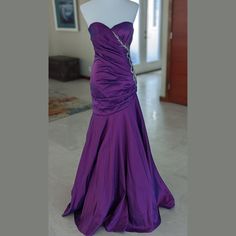 a purple dress is on display in a room