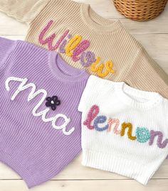 Our custom hand embroidered name sweaters are sure to look adorable on the sweet little one in your life!  Give them as gifts for baby showers, name announcements, first birthday's, Xmas gifts, and more!  Sweaters are a chunky knit and an oversized fit to wear as your baby grows.  These are perfect to wear in the fall, winter, or spring. Choose the color and size of your sweater in the above drop down.  Choose how many letters are in the name you want embroidered.  Fill in the personalization box with the name and thread color of your liking. Care Instructions Sweaters are made of 100% cotton.  Embroidery is made of 100% acrylic yarn.  We recommend to wash sweater inside out on delicate setting.  Do not wash with anything that has zippers, velcro, or heavy items to ensure your sweater last Cute Embroidered Knit Tops, Cute Cotton Sweater With Embroidered Logo, Customizable Cute Crew Neck Sweater, Customizable Cute Winter Sweater, Cute Customizable Crew Neck Sweater, Cute Customizable Winter Sweater, Cute Crew Neck Sweater With Custom Embroidery, Cute White Sweater With Embroidered Text, Cute White Embroidered Sweater