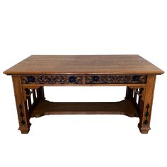 an old wooden table with carvings on the top and bottom shelf, against a white background