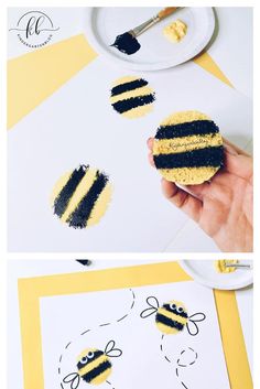 a hand holding a piece of cake that has been decorated to look like a bee