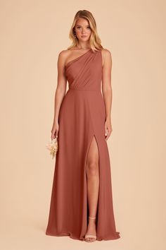 a bridesmaid in a one shoulder dress with thigh high slits and an asymmetrical neckline