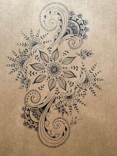 an artistic drawing on brown paper with flowers and swirls in the center is shown