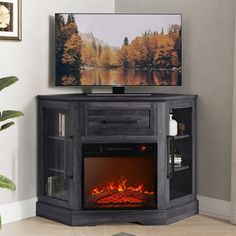 an entertainment center with a television and fire place