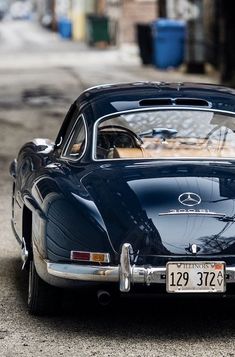 an old car parked on the side of the road