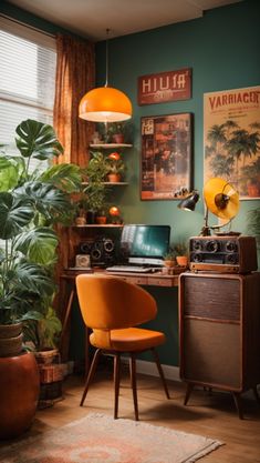 a room with a desk, chair, and plants in front of a window that has pictures on the wall