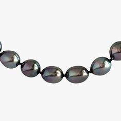 This Tahitian Pearl necklace is truly exceptional in its quality and beauty. With an oval clasp made of 14K white gold, this necklace is a timeless piece that will be cherished for generations. The necklace is 18 inches in length and weighs 47.6 grams. The pearls are cultured Tahitian pearls, with shades of Purple, Cherry, and Green Cherry that are absolutely breathtaking. The pearls vary in size from 8.5-10.0mm in width and 10-14mm in length, and they are semi-round, oval, and drop-shaped. The Classic Tahitian Pearl Necklace With Round Beads, Classic Tahitian Pearl Round Bead Necklaces, Classic Tahitian Pearl Round Bead Necklace, Formal Single Strand Tahitian Pearl Necklace, Classic Tahitian Pearl Beaded Necklace, Classic Round Tahitian Pearl Necklace, Classic Round Tahitian Pearl Necklaces, Classic Tahitian Pearl Round Necklaces, Classic Tahitian Pearl Necklace For Anniversary