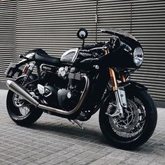 a black motorcycle parked in front of a building