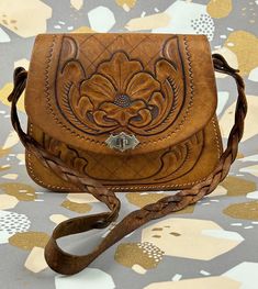 Stunning Handcrafted Vintage 1970s Tooled Leather Shoulder Bag / Satchel - Lovely handmade brown leather bag with hand Tooled detailing and plaited strap.  - this is just beautiful and very vintage - perfect for a special night out! - this bag is vintage and has been used previously. It has a very rustic look with lots of character.  - It's in good vintage condition, has been repaired at the back - see photos for details - Item measures approx: without handle/strap - 20cm tall x 25cm wide x 5cm Vintage Light Brown Shoulder Bag For Daily Use, Vintage Brown Bag With Adjustable Strap, Vintage Light Brown Shoulder Bag With Adjustable Strap, Vintage Light Brown Satchel For Daily Use, Handmade Vintage Brown Bag, Vintage Brown Hand Tooled Satchel For Daily Use, Vintage Light Brown Crossbody Shoulder Bag, Vintage Light Brown Satchel Shoulder Bag, Vintage Light Brown Satchel With Adjustable Strap