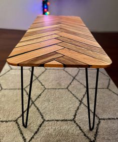 a wooden table sitting on top of a rug