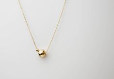 "Minimalistic, classy and elegant! This necklace is perfect for any occasion. Shinny Beads in sterling silver or gold filled. A perfectly Shinny ball bead pendants threated on a delicate feminine 14K gold filled chain. Simple and dainty gold ball necklace, featuring 14K gold filled ball and chain /Sterling silver ball and chain. ■ Turn this necklace also a Back necklace! Check out our clip on Back Necklace Chain : https://www.etsy.com/listing/250871895/mini-bead-back-necklace-dainty-beck-drop?re Necklaces Modern, Gold Ball Necklace, Classy Necklace, Dainty Necklaces, Dot Necklace, Real Gold Jewelry, Back Necklace, Etsy Bridesmaid Gifts, Ball Necklace