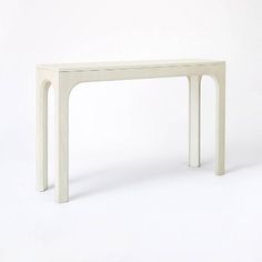 a white table sitting on top of a white floor