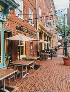 tables and chairs are lined up on the brick sidewalk