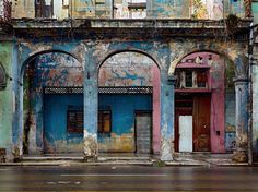 an old building with blue and pink paint