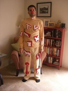 a man in a costume standing next to a book shelf