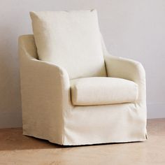 a white chair sitting on top of a hard wood floor