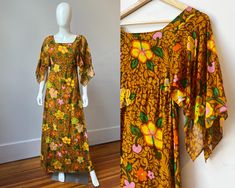 This authentic 1960s Tahitian made dress will bring the tropics to wherever you wear it!  This vintage 60s maxi dress features beautiful flutter sleeves and a fun retro tropical hibiscus print made of mocha and caramel browns, orange, yellow, pink, lime green, and grass green.  The bust and body of the dress are lined with a second layer of the printed fabric while the sleeves flow freely unlined a touch more sheer.  A white zipper in the back of the dress makes this a fitted empire waist column style dress with an illusion of being a slim caftan. It was made in Papeete, the capital of the island of Tahiti in French Polynesia, by Designer "Marie Ah You Couture" and is made of a lightweight cotton gauze.  Tag: Marie Ah You Couture Papeete_Tahiti Material: Thin Woven Cotton  Size: US size S/ Papeete Tahiti, 60s Maxi Dress, Hostess Gown, Retro Tropical, Maxi Dress Vintage, Hibiscus Print, Tropical Hibiscus, Cotton Maxi Dress, Mai Tai