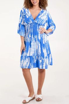 Elevate your style with our Relaxed Fit 3/4 Sleeves Shirred Waist Printed V Neck Mini Dress in Blue and White, expertly crafted from luxurious viscose. The timeless blue and white print exudes sophistication and charm, perfect for any occasion. Featuring 3/4 sleeves and a shirred waist, it offers a flattering silhouette with comfort in mind. The V-neck adds a touch of allure to this versatile mini dress, making it ideal for both casual outings and special events. Step out in style with this chic Casual Summer Dresses With 3/4 Sleeves, Summer Beach Mini Dress, Mid-length, Flowy Dresses With 3/4 Sleeves For Vacation, Beach Dresses With 3/4 Sleeves For Summer, Summer Vacation Dress With Half Sleeves, Summer Vacation Dresses With Half Sleeves, Half Sleeve Summer Vacation Dresses, Spring Beach Dress With Half Sleeves, Spring Beach Dresses With Half Sleeves