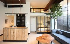 a living room filled with furniture next to a kitchen