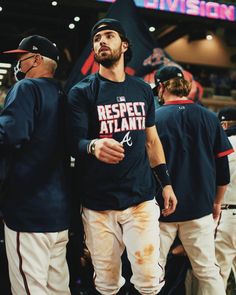 two baseball players are standing next to each other