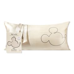 a pillow with a mickey mouse drawn on it and a tag attached to the pillow