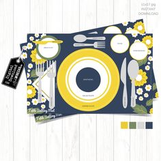 a place mat with yellow and blue flowers on it next to a fork, knife, spoon