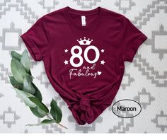 a t - shirt that says 80 and fabulous with a crown on the front in white