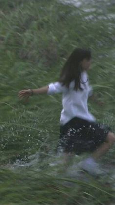 a woman in the water with her arms outstretched