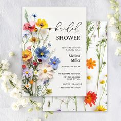 a floral bridal shower is displayed on a white background with daisies and wildflowers