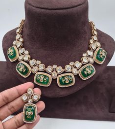 Sabyasachi's Inspired Emerald Polki Necklace is a breathtaking showcase of green Kundan and Polki jewelry, characterized by its exquisite craftsmanship. This necklace embodies the elegance of uncut Polki diamonds and seamlessly combines them with traditional Jadau and Kundan work. The rich green hues of the emeralds enhance the regal allure, making it a timeless piece. This necklace is a harmonious blend of tradition and contemporary aesthetics, celebrating the opulence of Polki and Kundan jewel Designer Green Jewelry For Formal Occasions, Designer Green Jewelry For Gifts, Designer Green Jewelry As Gift, Designer Green Jewelry As A Gift, Emerald Meenakari Kundan Necklace For Wedding, Green Kundan Bridal Necklace Hand Set, Traditional Emerald Kundan Necklace For Formal Occasions, Wedding Kundan Necklace With Emerald Intricate Design, Green Kundan Necklaces For Wedding