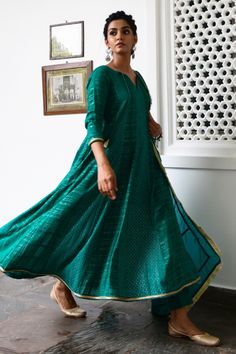 Emerald green anarkali with woven stripes, tassel tie-up neck, gota trims and dotted motifs. Comes with pants and fringe border dupatta.
Component: 3
Embroidered
Neckline: Round
Sleeve Length: Long
Fabric: Anarkali: Cotton Lurex; Dupatta: Organza; Lining: Cotton; Pant: Cotton Silk
Color: Green
Tassel tie-up neck
Fringe dupatta - Aza Fashions Traditional Green Maxi Kurta, Traditional Green Maxi Length Kurta, Green Handloom Kurta For Navratri, Green Self Design Dress For Celebration, Green Maxi Length Kurta For Navratri, Green Anarkali Kurta For Transitional Season, Handloom Anarkali Salwar Kameez, Anarkali Handloom Sharara For Eid, Anarkali Style Handloom Sharara For Eid