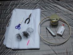 scissors, thread, and other items are on a sheet