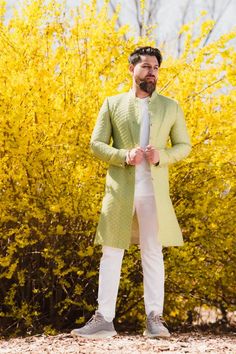 Olive Green Sherwani made with a gorgeous raw silk fabric embroidered with thread and gold sequin. Paired with white straight- leg pants Designer Pista Green Sherwani With Intricate Embroidery, Festive Full Length Kurta, Spring Nehru Jacket With Dabka Work, Festive Pista Green Sherwani With Intricate Embroidery, Pista Green Sherwani With Dabka Work For Festivals, Pista Green Sherwani With Dabka Work For Eid, Pista Green Sherwani With Resham Embroidery For Festive Occasions, Festive Full-length Traditional Wear With Dabka Work, Bollywood Style Pista Green Bandhgala With Resham Embroidery