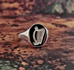 Large oval heavyweight solid sterling silver men's ring. Hand engraved Irish Harp, Ireland Rugby Signet. Depth is sufficient for engraving, which we are not able to provide at present as it is a specialism in its own right. Hallmarks struck in Birmingham UK. Main oval plate size is 14mm long and 12mm across. Rounded high polished finish. Pictured in size X (UK/AU) size 11 1/2 (US). Signet ring weighs 7.9 grams. 925 sterling silver quality. For additional sizes please enquire first. Comes presented in our sustainable FSC certified branded box. Engraved Oval Signet Ring For Commemoration, Classic Engraved Signet Ring For Memorial, Classic Engraved Ring For Memorial, Oval Hallmarked Signet Ring For Commemoration, Classic Engraved Memorial Rings, Oval Signet Ring With Polished Finish For Commemoration, Classic Engraved Ring With Polished Finish For Commemoration, Classic Oval Engraved Ring For Commemoration, Oval Sterling Silver Engraved Ring