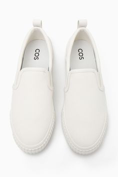 These slip-on trainers are an easy option for summer dressing – they'll go with all your casual outfits but will work equally well to pare back tailoring, too. Crafted from cotton-canvas with leather detailing, they come in versatile white and have chunky rubber soles and elasticated inserts for comfort. The leather pull tab at the back makes them easy to slip on and off. Leather binding and panellingRecycled cotton is made by converting both pre- and post-consumer fabric into fibres that are then spun into new yarn Shell & Lining: 80% Cotton, 20% Recycled cotton, Sole: 80% Rubber, 20% Recycled rubber Casual White Slip-on Platform Sneakers, Summer Slip-on Sneakers With Vulcanized Sole, Spring Cotton Slip-ons With Rubber Sole, White Slip-ons With Rubber Sole For Summer, White Slip-on Sneakers For Everyday, White Textile Low-top Slip-ons, White Low-top Loafers With Stitched Sole, Sporty Cotton Slip-on Sneakers, White Canvas Shoes With Rubber Sole For Everyday