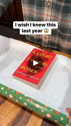 a person holding a book in front of a box with writing on it that says i wish i knew this last year