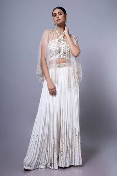 White padded blouse featuring floral hand embroidery all over. Paired with an embroidered palazzo and a sheer cape. - Aza Fashions Elegant Designer Choli With Floral Embroidery, Intricate Embroidery Top For Wedding, Intricate Embroidery Embroidered Top For Wedding, Elegant Floral Embroidered Georgette Choli, Silk Top With Dupatta For Wedding, Silk Dupatta Top For Wedding, Silk Wedding Top With Dupatta, Elegant Sleeveless Set With Intricate Embroidery, Elegant Sleeveless Sets With Intricate Embroidery